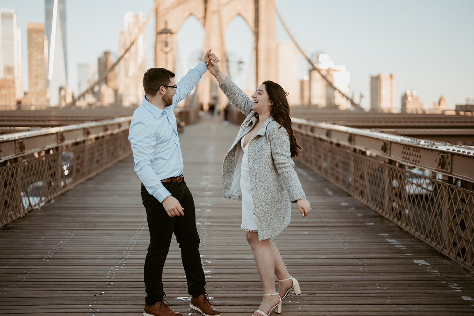 engaged couple dancing on the Brooklyn bridge